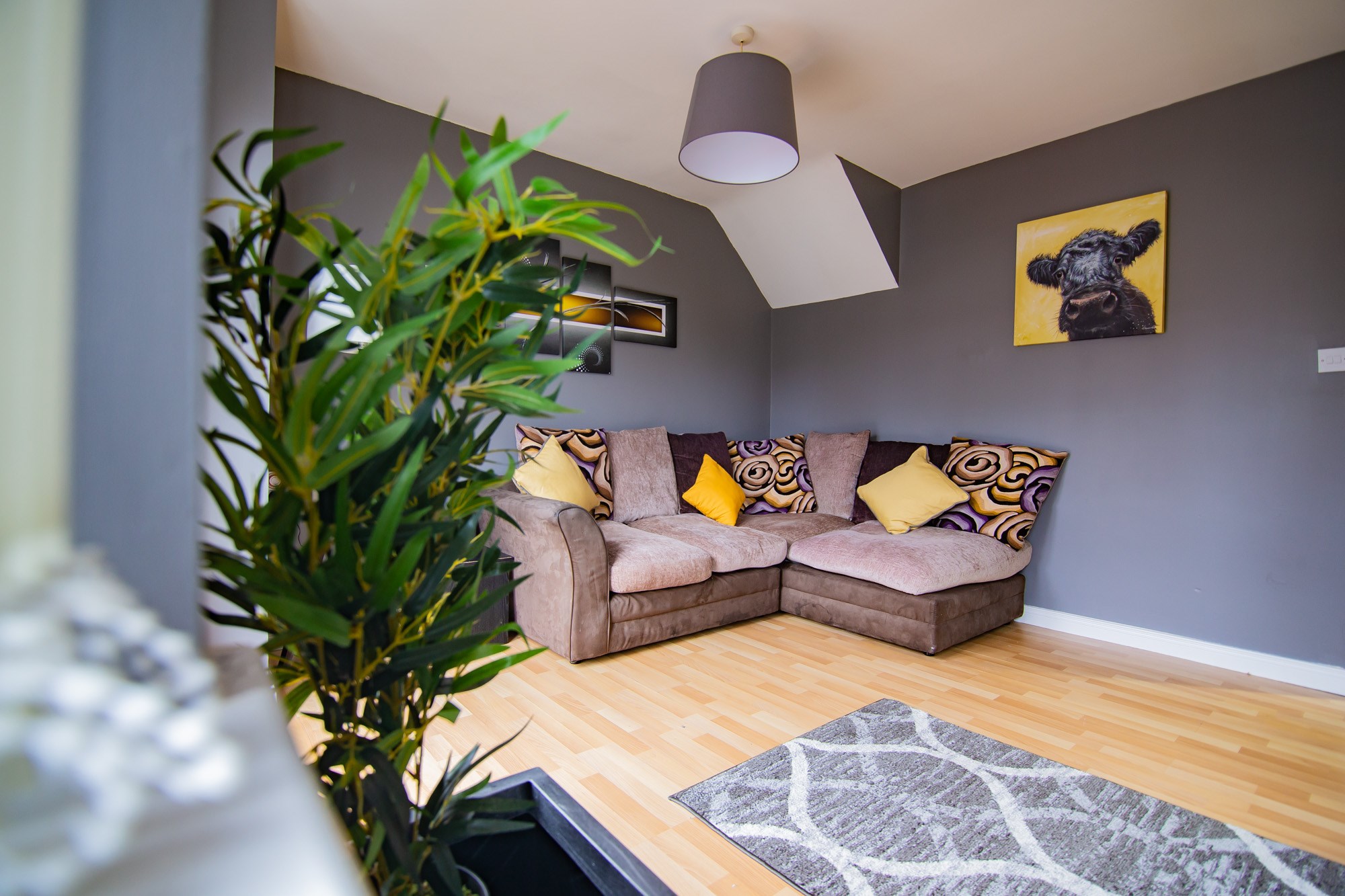 Lounge with corner sofa and indoor plant