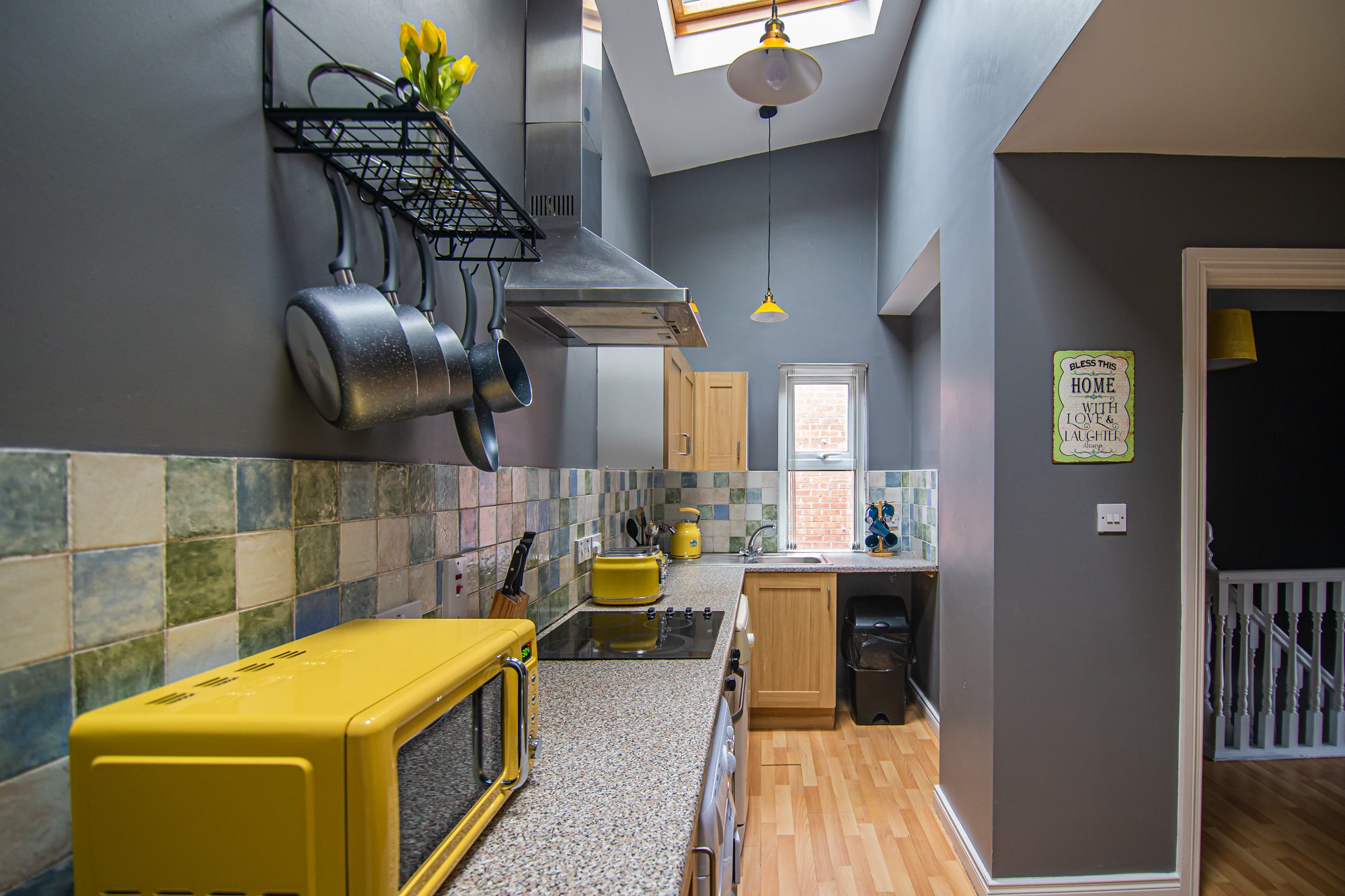 Kitchen with tiled splashback and yellow appliances